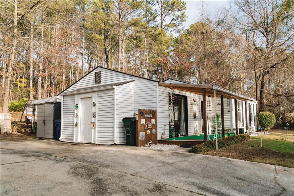 3184 Newcastle Way Snellville, GA 30039 - Photo 3 of 36 a view of a white house with a large windows and a yard