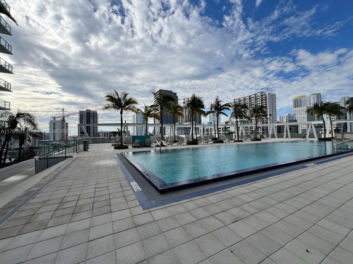 79 Southwest 12th Street, Unit 1710S Miami, FL 33130 - Photo 16 of 18 a view of swimming pool with outdoor seating