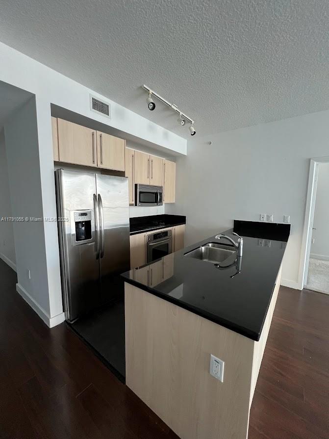 79 Southwest 12th Street, Unit 1710S Miami, FL 33130 - Photo 4 of 18 a kitchen with stainless steel appliances granite countertop a refrigerator a stove and a sink