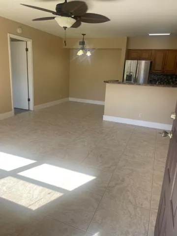 en empty room with window and ceiling fan