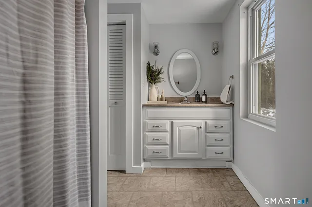 a bathroom with a mirror a sink and a mirror