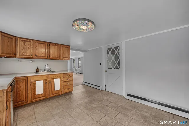 a large white kitchen with a sink and cabinets