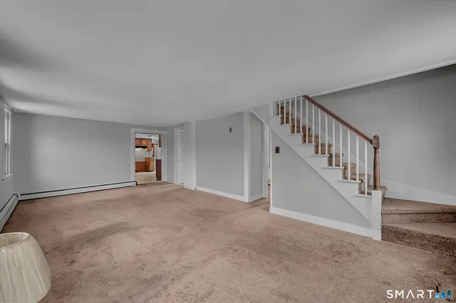 a view of an empty room with stairs