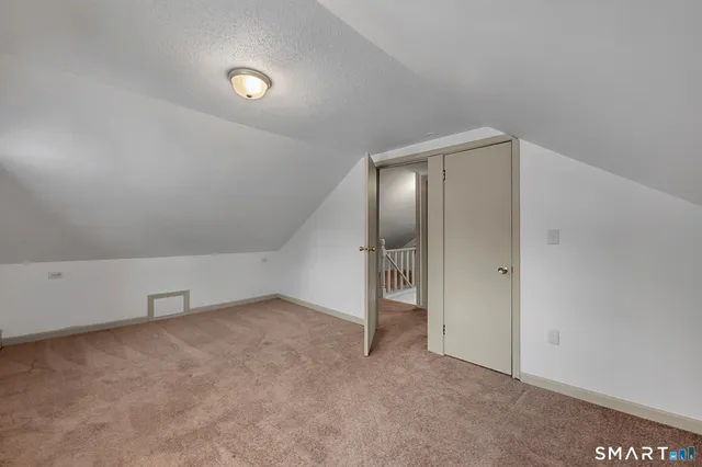 an empty room with glass door and shower