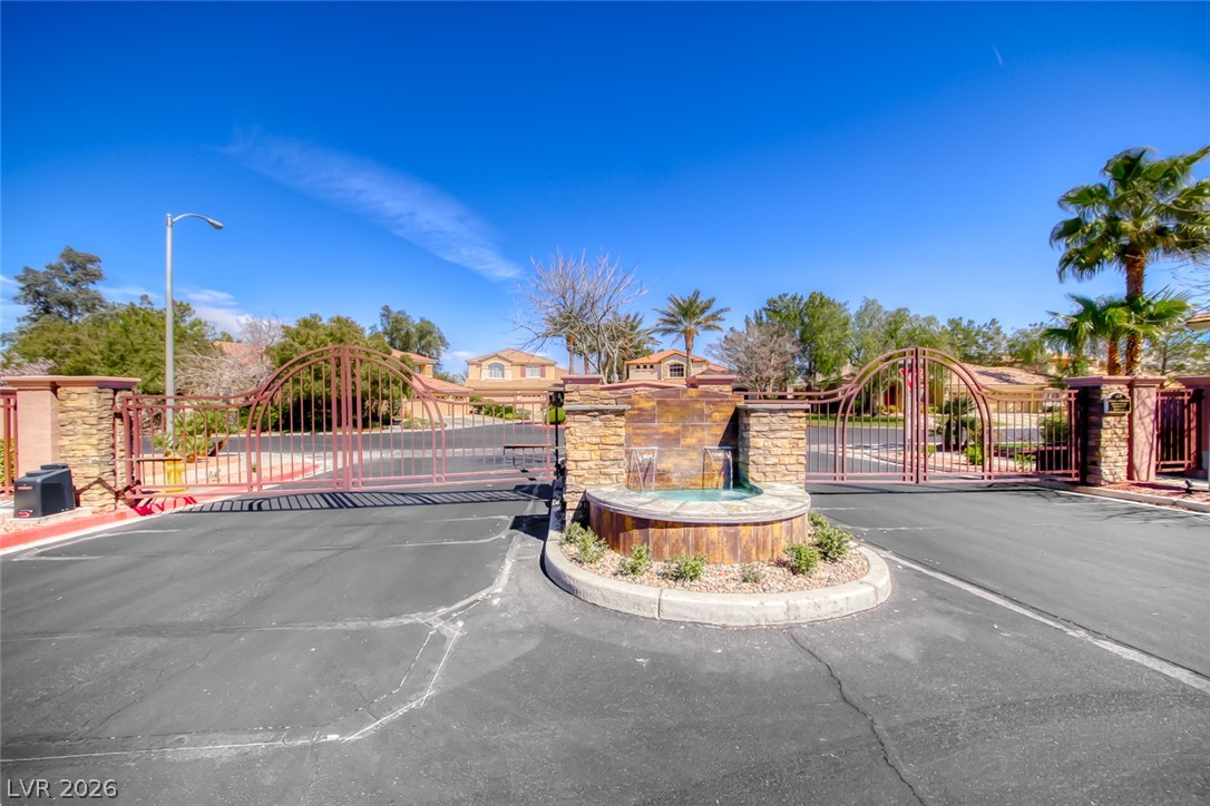 2122 Mooreview Street Henderson, NV 89012 - Photo 42 of 44 A grand gated entrance welcomes residents to this private community, featuring an elegant stone fountain.