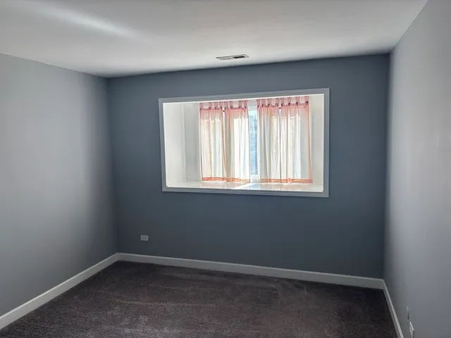 a kitchen with a refrigerator sink and cabinets
