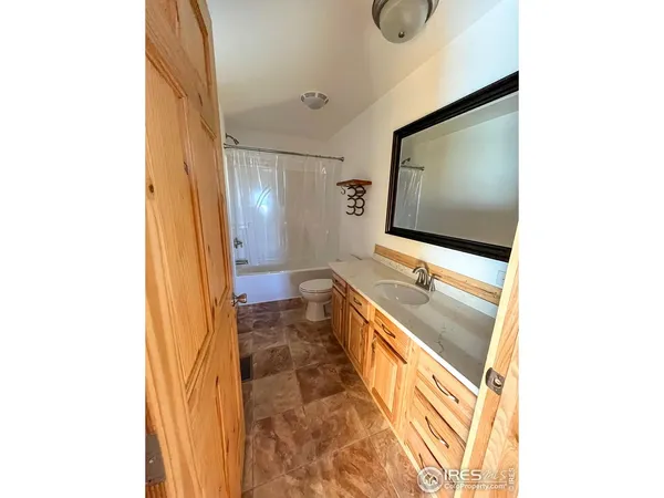 a bathroom with a sink a mirror and shower