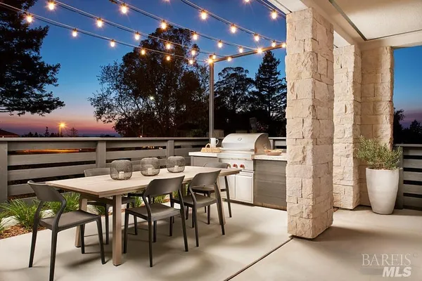 a outdoor dining space with furniture and a potted plant