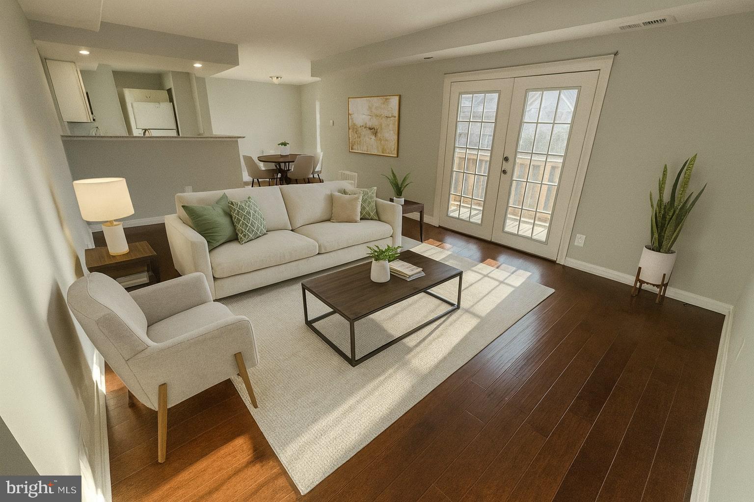 a living room with furniture and a wooden floor