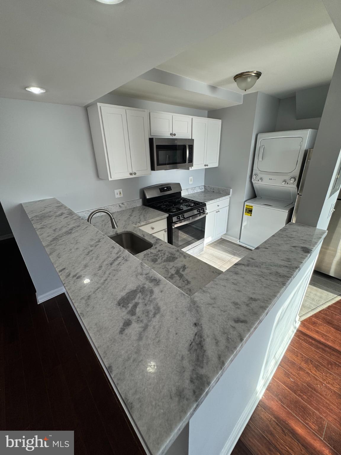 2500 Markham Lane, Unit 2 Landover, MD 20785 - Photo 11 of 27 a living room with stainless steel appliances kitchen island granite countertop furniture a sink a stove and a wooden floors