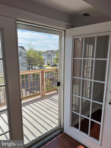 a view of a balcony with wooden floor and windows