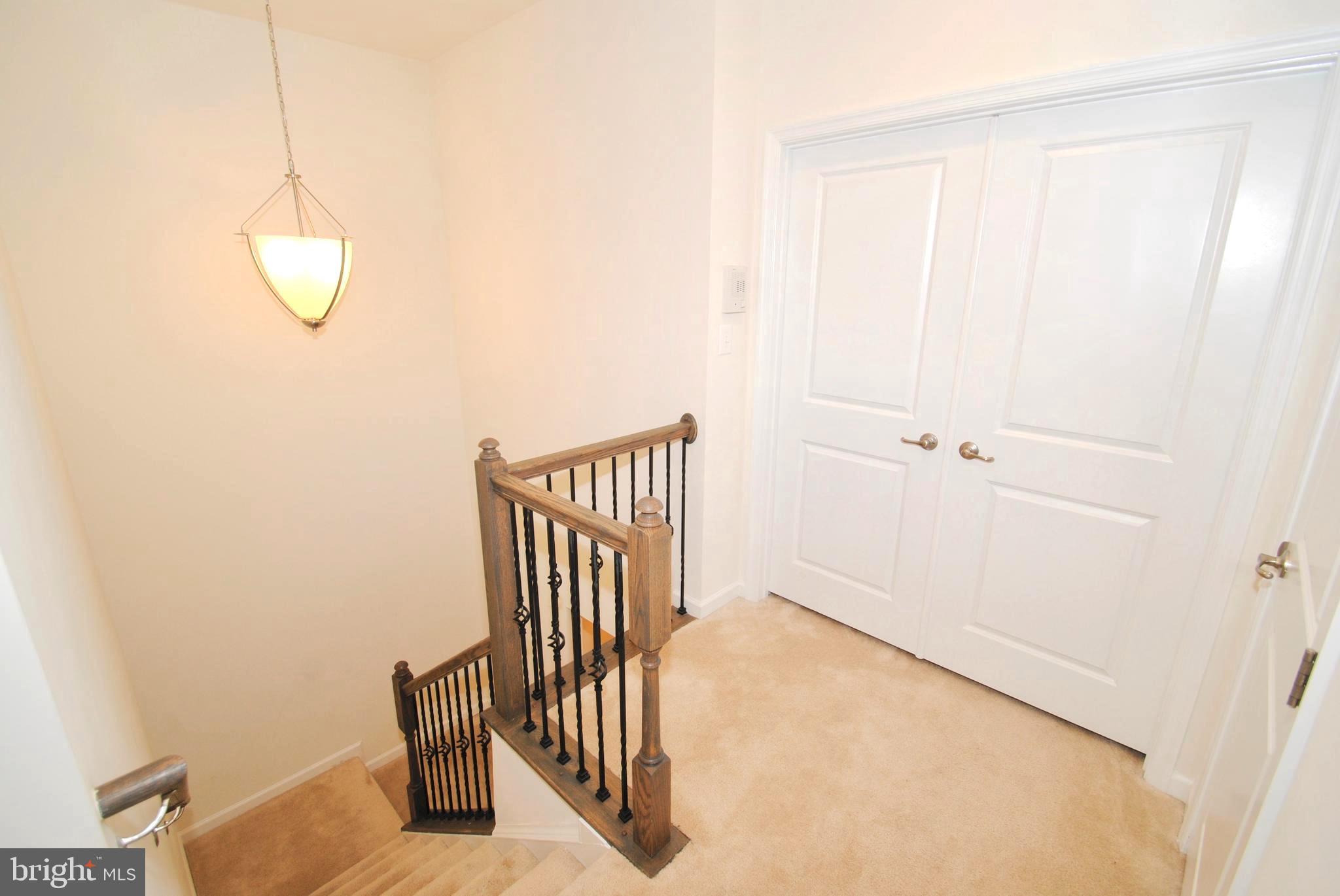 8038 Orchard Grove Road, Unit 20 Odenton, MD 21113 - Photo 19 of 30 Chandeliered Upper Landing . Neutral Carpeting