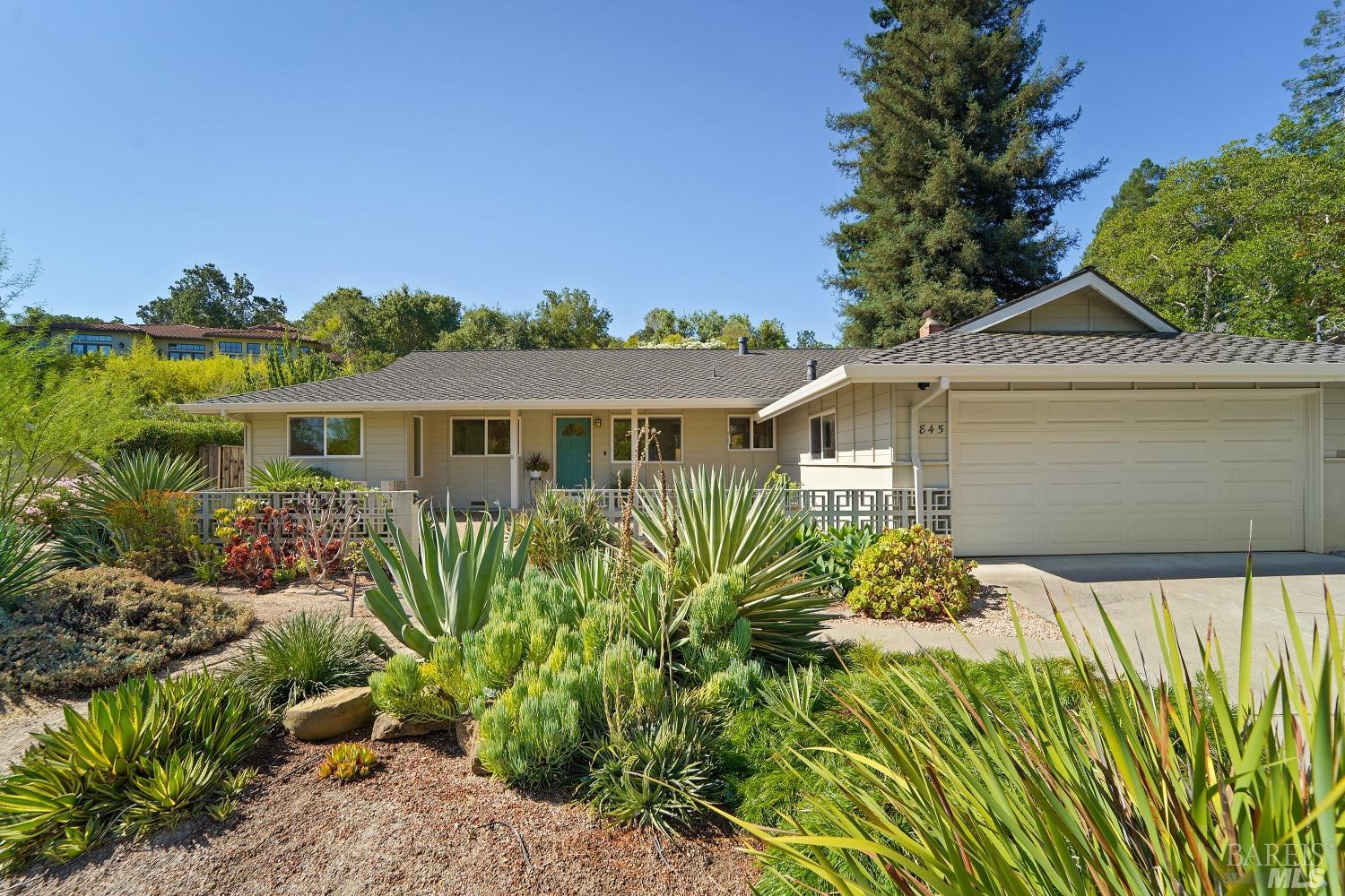 a front view of a house with a garden