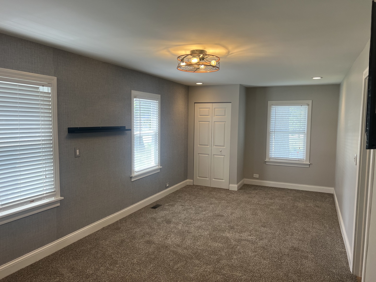 7830 Westview Lane Woodridge, IL 60517 - Photo 10 of 26 an empty room with windows and chandelier fan
