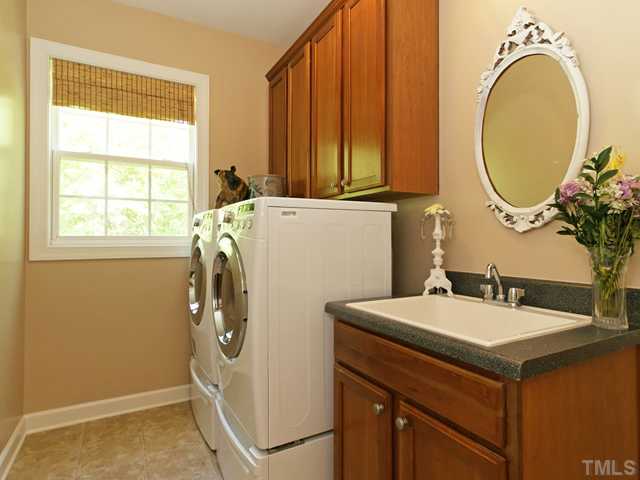 4449 Fairview Ridge Lane Apex, NC 27539 - Photo 21 of 25 1ST FLOOR LAUNDRY ROOM WITH CABINETRY AND SINK!
