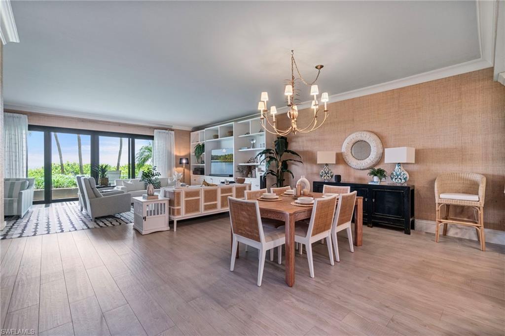 176 South Collier Boulevard, Unit 101 Marco Island, FL 34145 - Photo 13 of 50 a view of a dining room with furniture window and wooden floor