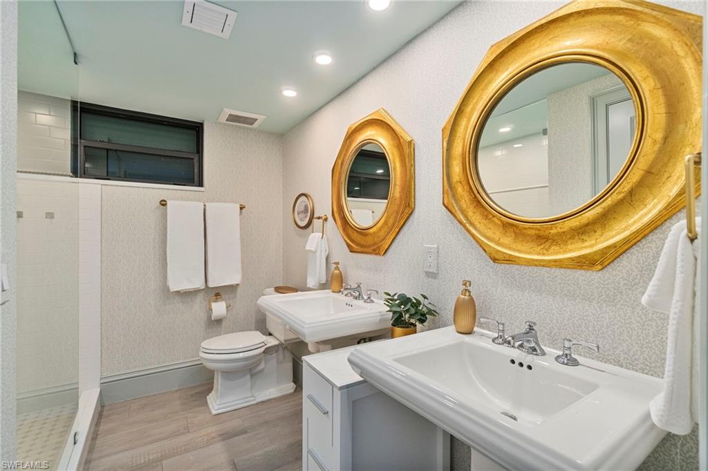176 South Collier Boulevard, Unit 101 Marco Island, FL 34145 - Photo 25 of 50 a bathroom with a sink and a mirror