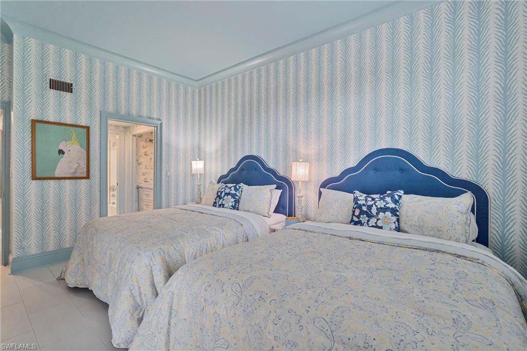 176 South Collier Boulevard, Unit 101 Marco Island, FL 34145 - Photo 29 of 50 a bedroom with a bed and a painting on the wall