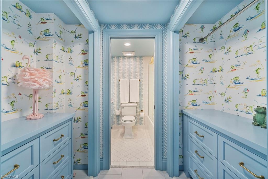 176 South Collier Boulevard, Unit 101 Marco Island, FL 34145 - Photo 30 of 50 a bathroom with a granite countertop sink a mirror and shower