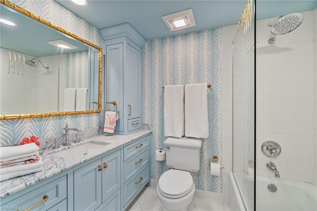 176 South Collier Boulevard, Unit 101 Marco Island, FL 34145 - Photo 32 of 50 a bathroom with a granite countertop sink toilet and shower