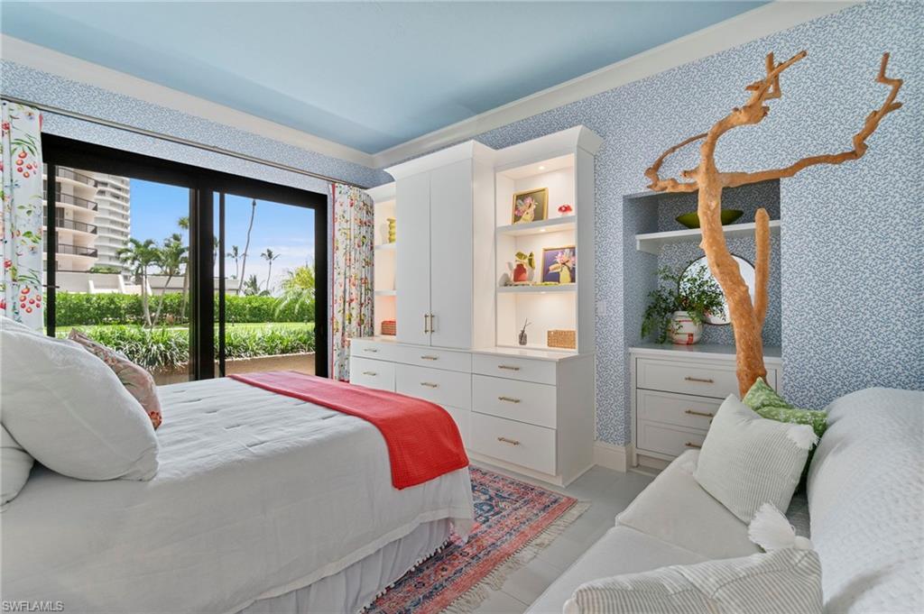 176 South Collier Boulevard, Unit 101 Marco Island, FL 34145 - Photo 33 of 50 a bedroom with a bed and a window