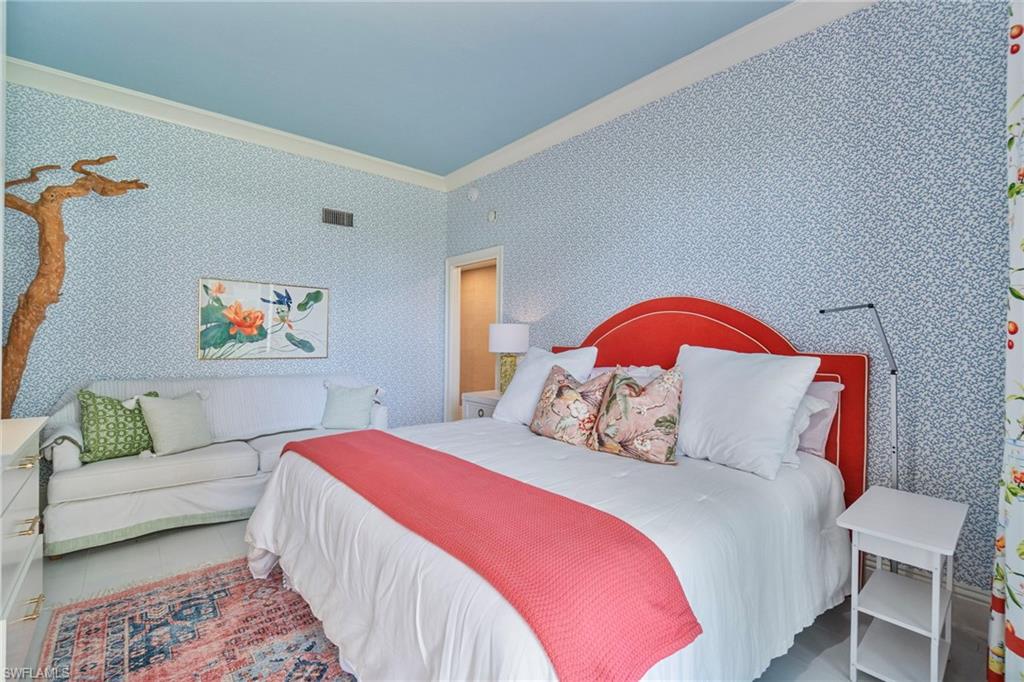 176 South Collier Boulevard, Unit 101 Marco Island, FL 34145 - Photo 34 of 50 a bedroom with a bed and a couch