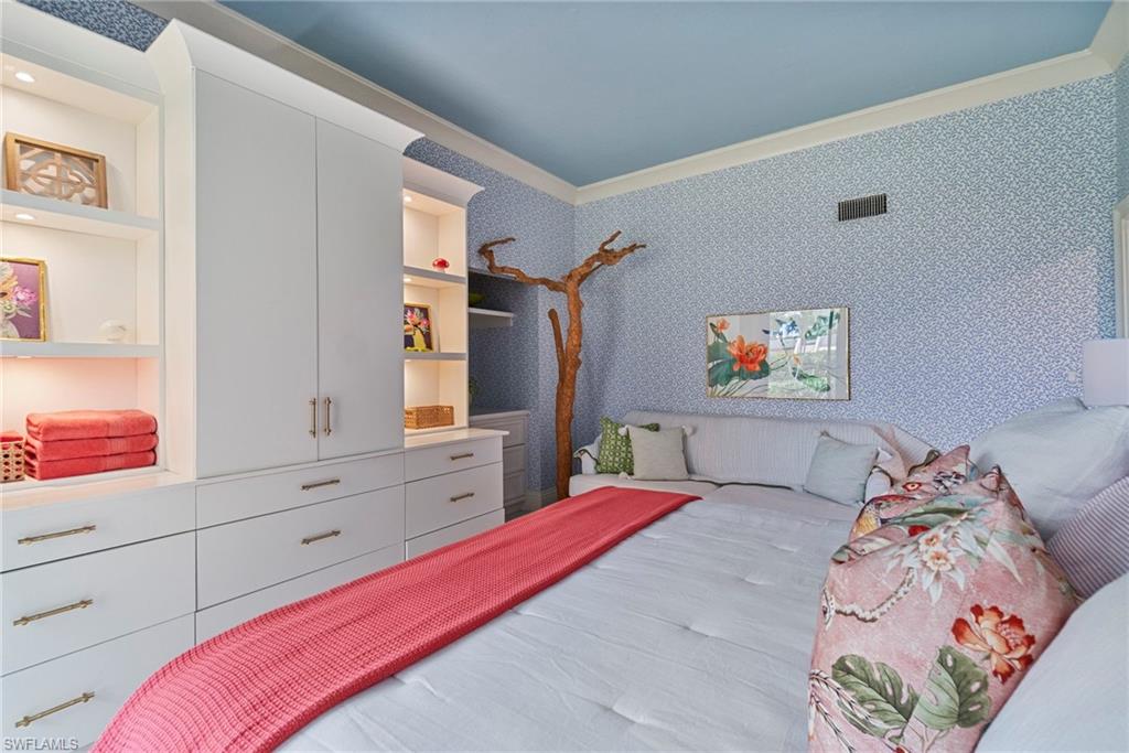 176 South Collier Boulevard, Unit 101 Marco Island, FL 34145 - Photo 35 of 50 a bedroom with a bed and a dresser in it