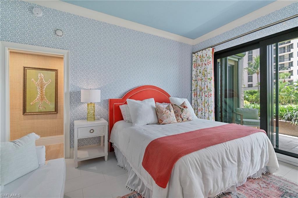 176 South Collier Boulevard, Unit 101 Marco Island, FL 34145 - Photo 8 of 50 a bedroom with a bed and a window