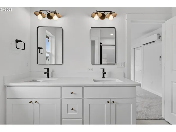 a bathroom with a sink vanity granite and a shower