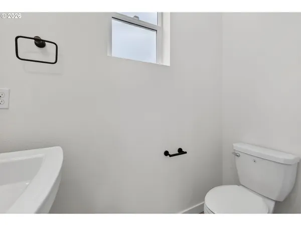 a bathroom with a shower a toilet and a tub