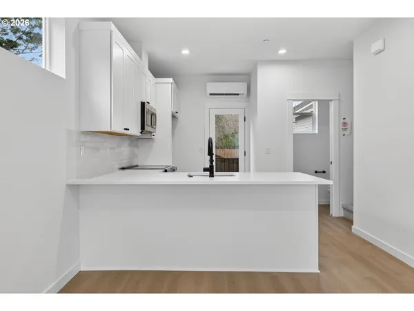 a view of a kitchen with a sink and cabinets