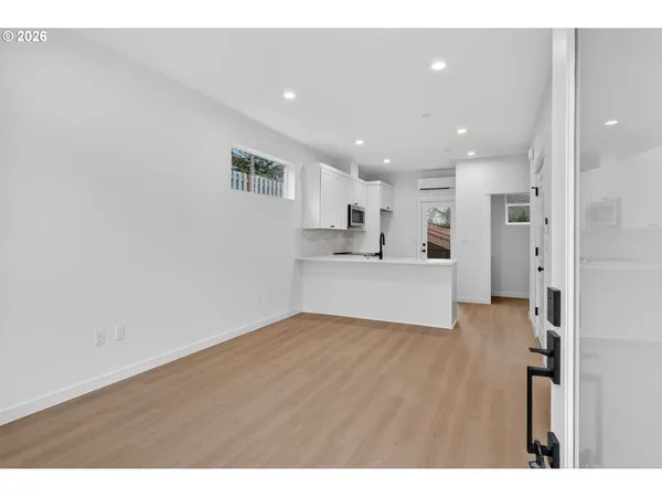 a view of a kitchen with wooden floor