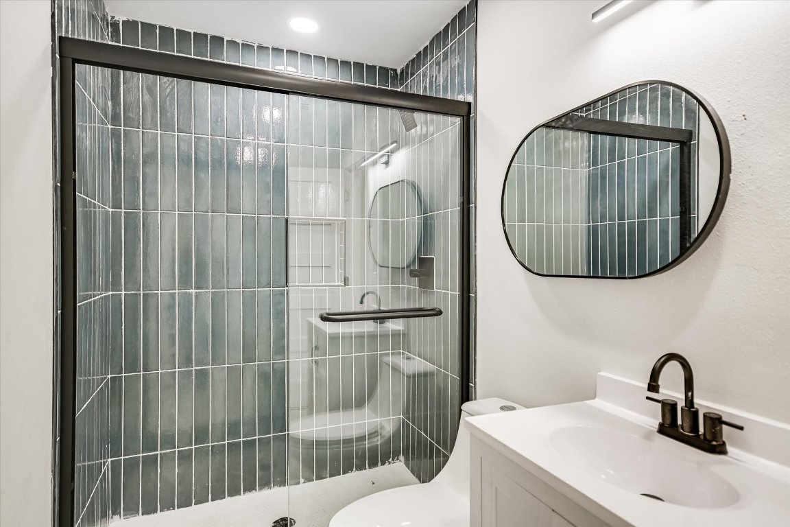 52 War Bonnet Wimberley, TX 78676 - Photo 23 of 31 a bathroom with a sink a toilet and a mirror