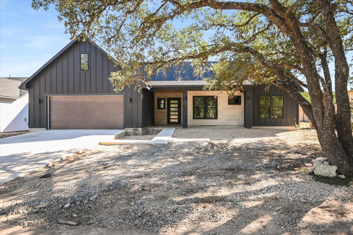 52 War Bonnet Wimberley, TX 78676 - Photo 3 of 31 a front view of a house with a large tree