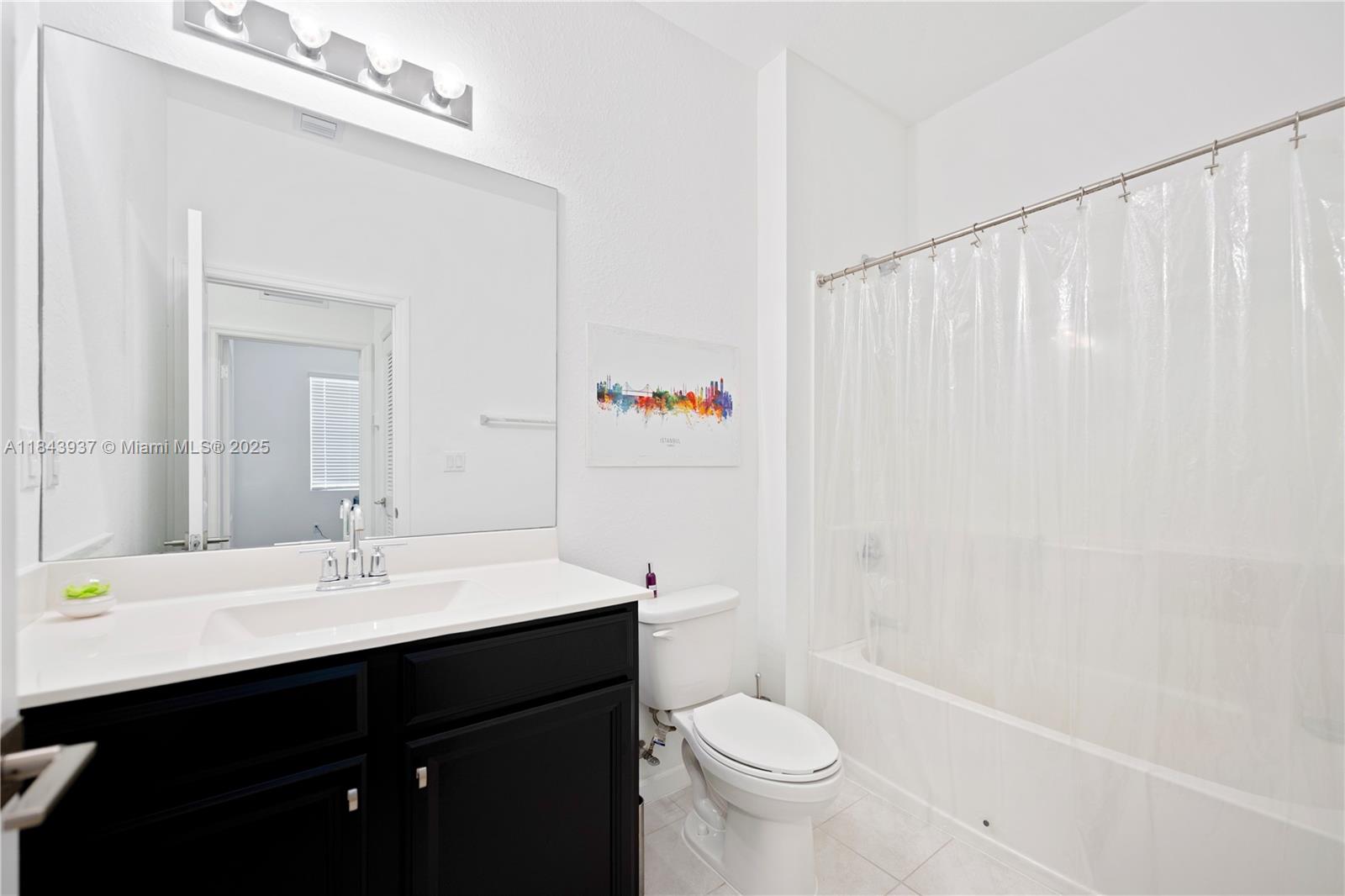 1106 Northwest 40th Terrace Lauderhill, FL 33313 - Photo 12 of 20 a bathroom with a sink a toilet and shower curtain