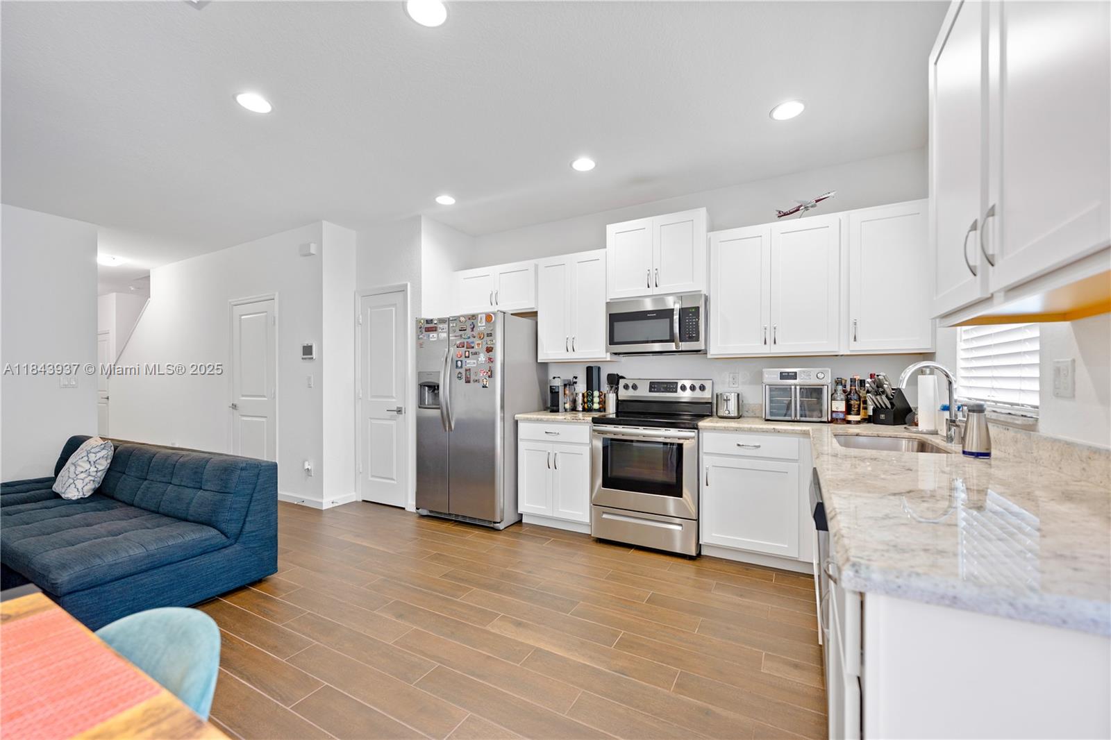 1106 Northwest 40th Terrace Lauderhill, FL 33313 - Photo 6 of 20 a kitchen with stainless steel appliances granite countertop a refrigerator sink and stove