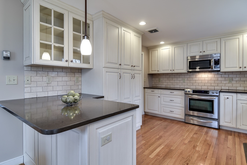 3 Swanson Road Framingham, MA 01701 - Photo 13 of 38 a kitchen with stainless steel appliances granite countertop a sink and a stove