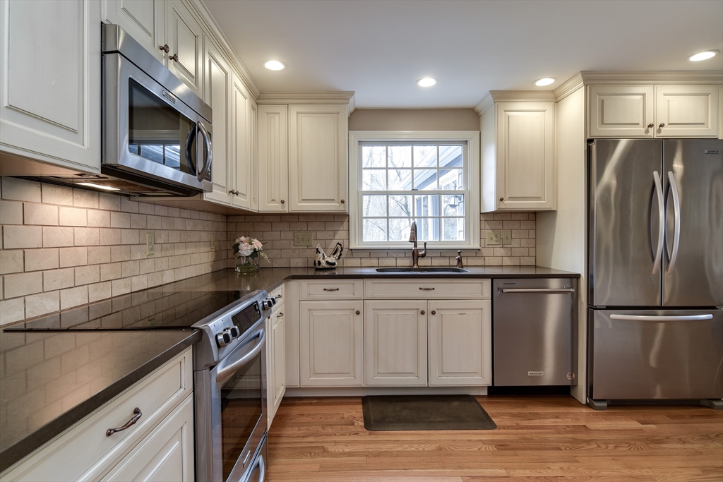 3 Swanson Road Framingham, MA 01701 - Photo 15 of 38 a kitchen with stainless steel appliances granite countertop a sink a stove a microwave and cabinets