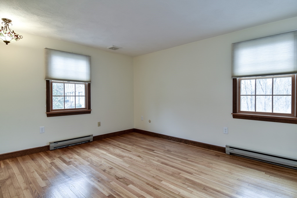 3 Swanson Road Framingham, MA 01701 - Photo 16 of 38 a view of an empty room with wooden floor and a window