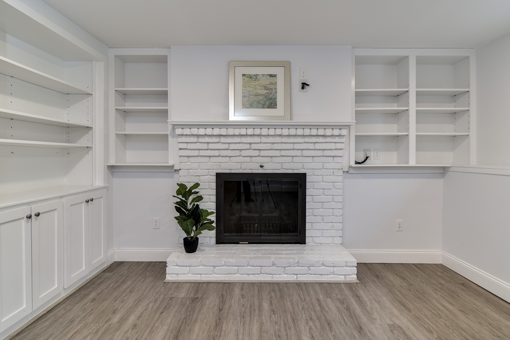 3 Swanson Road Framingham, MA 01701 - Photo 23 of 38 a living room with a fireplace and a potted plant