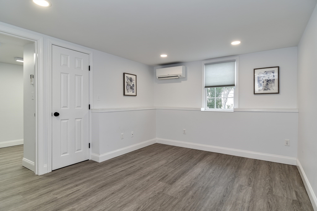 3 Swanson Road Framingham, MA 01701 - Photo 28 of 38 an empty room with wooden floor and windows