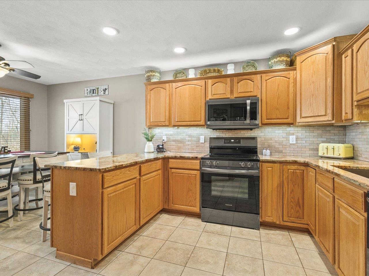 968 Falcon Point Place Rockton, IL 61072 - Photo 11 of 38 a kitchen with stainless steel appliances granite countertop a stove top oven a sink dishwasher and a microwave oven on the blue kitchen countertops