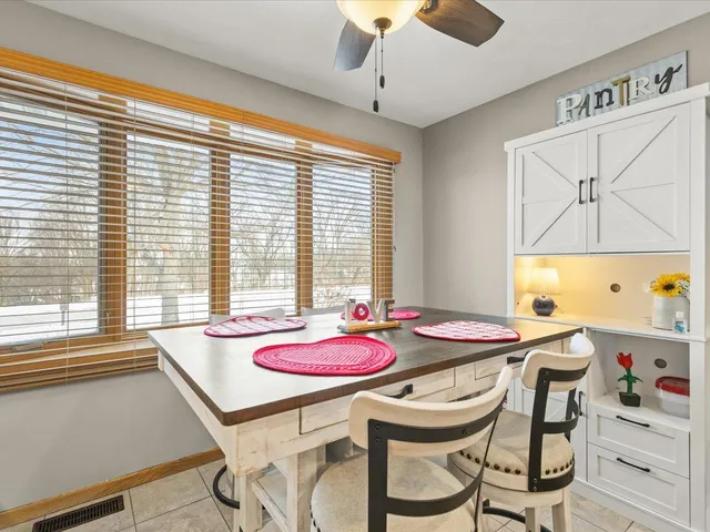 a dining room with furniture and window