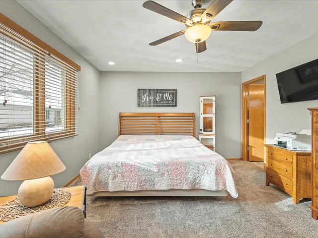 a bedroom with a large bed and flat tv