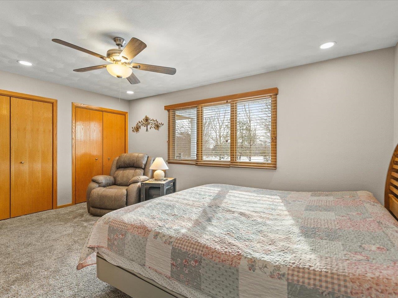968 Falcon Point Place Rockton, IL 61072 - Photo 19 of 38 a bedroom with a large bed and a chandelier