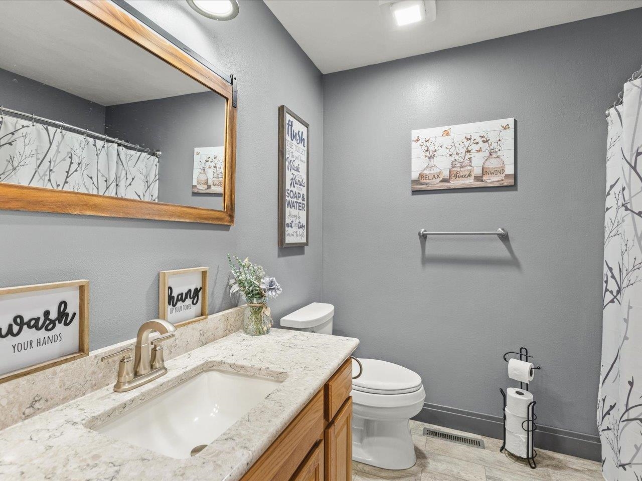 968 Falcon Point Place Rockton, IL 61072 - Photo 21 of 38 a bathroom with a granite countertop toilet sink and mirror