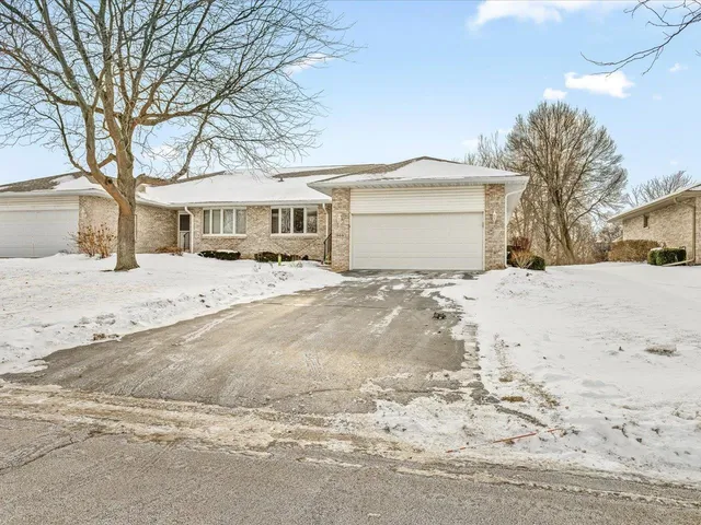 a view of house with a yard covered in snow