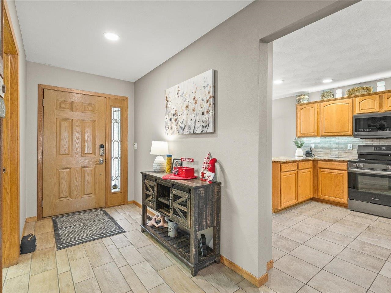 968 Falcon Point Place Rockton, IL 61072 - Photo 10 of 38 a kitchen with stainless steel appliances a stove a sink and a refrigerator