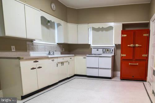 2504 Queen Anne Road Baltimore, MD 21216 - Photo 11 of 36 a kitchen with granite countertop white cabinets and white stainless steel appliances