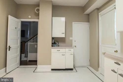 a spacious bathroom with a granite countertop sink and a mirror